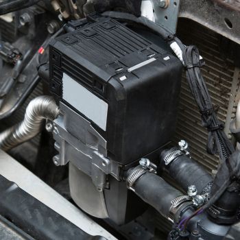 Car heater repair component showing a heater control unit and associated hoses, relevant to automotive repair services offered by Asher Auto Care in Dallas, TX.