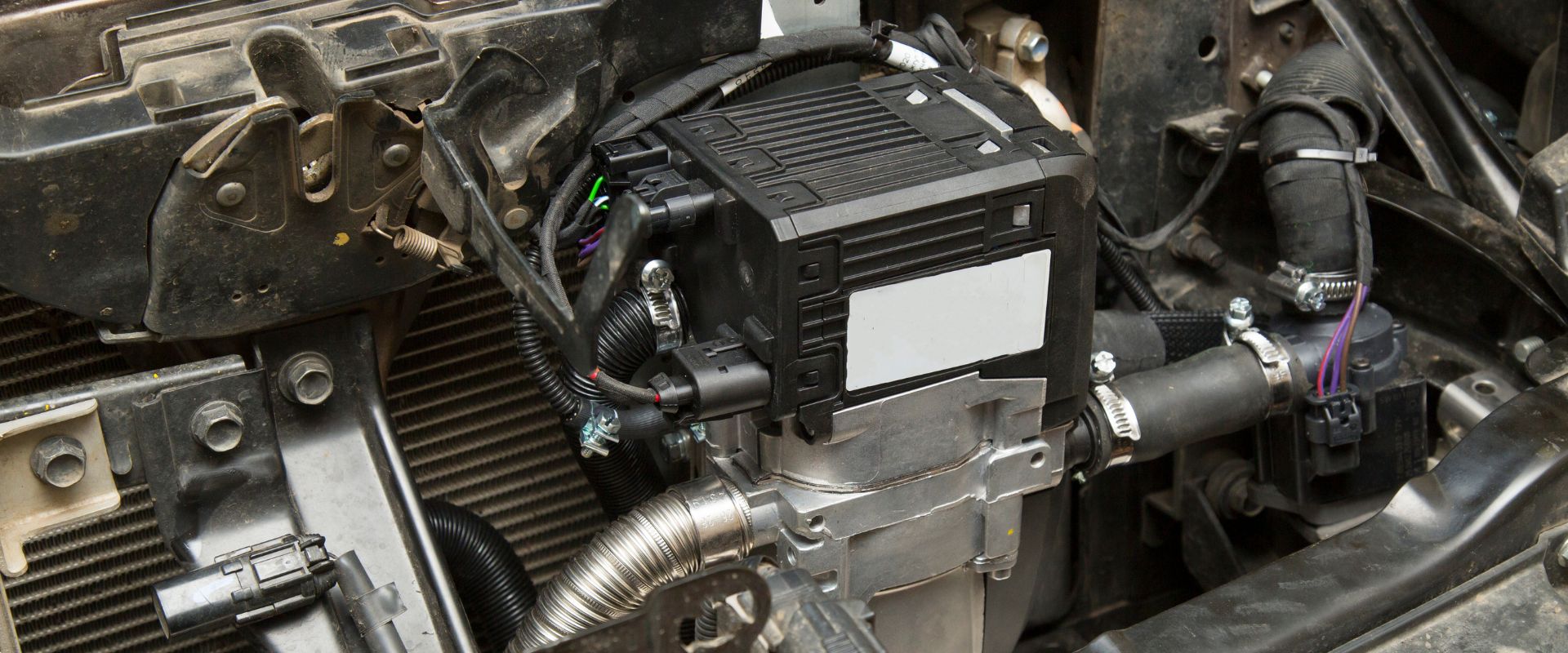 Car heater components including a heater core and electrical connections, highlighting mechanical details relevant to heater repair services in Dallas, TX.