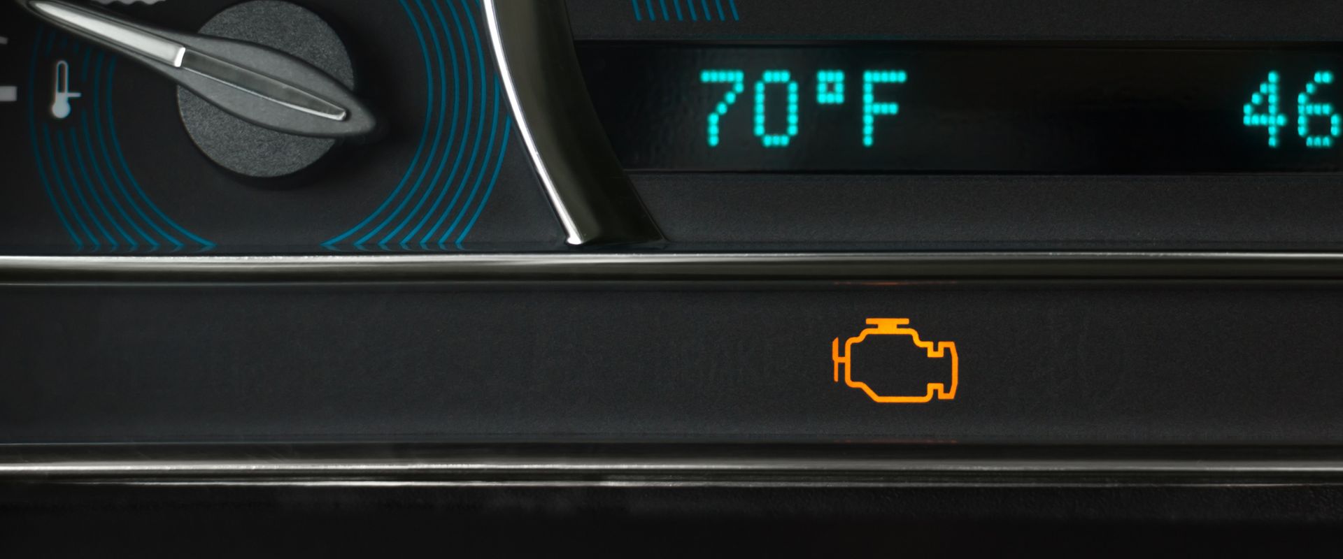Check engine light illuminated on vehicle dashboard, indicating potential engine issues, with temperature display showing 70°F.