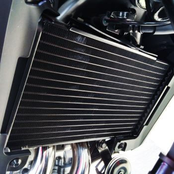 Cooling system component, showcasing a radiator with fins, relevant to automotive repair services offered by Asher Auto Care in Dallas, TX.