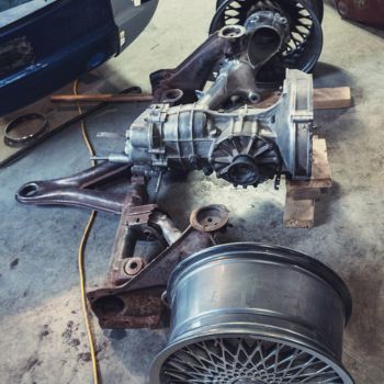 Drivetrain and differential components displayed in an auto repair workshop, highlighting automotive repair services at Asher Auto Care in Dallas, TX.