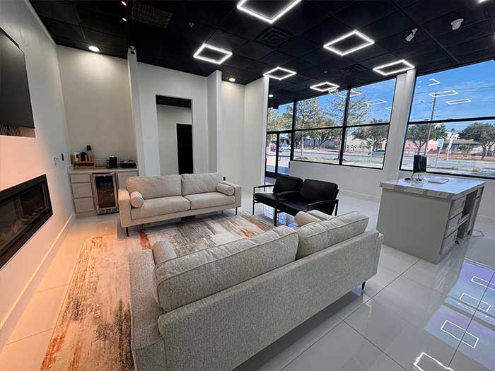 Modern waiting area at Asher Auto Care, featuring comfortable seating, large windows with natural light, and a sleek design, emphasizing customer comfort during vehicle service.