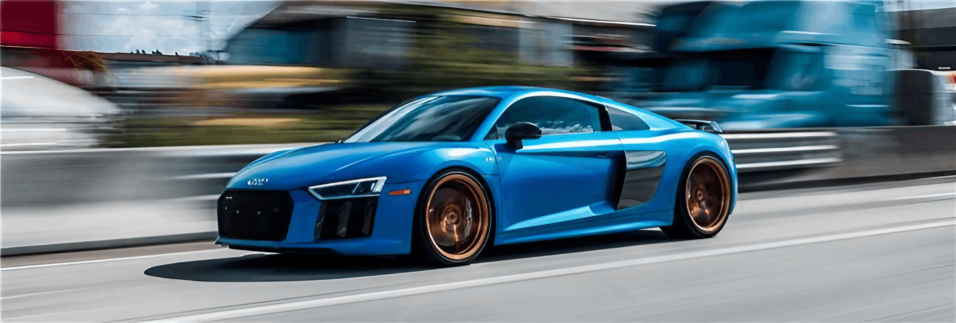 Blue Audi R8 sports car in motion on a highway, showcasing sleek design and performance, representing quality auto care and repair services at Asher Auto Care in Dallas, TX.