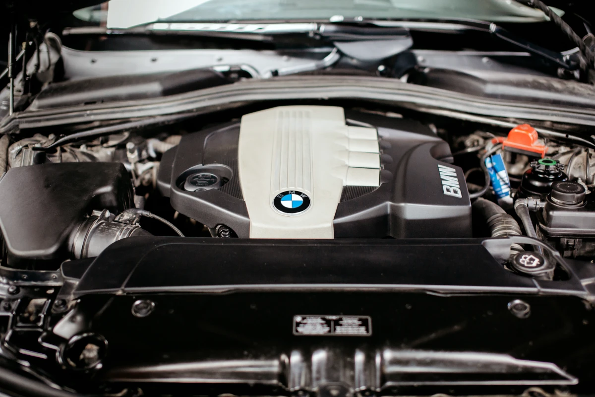 BMW engine under the hood, showcasing essential components and the BMW logo, relevant to vehicle maintenance and repair tips at Asher Auto Care.