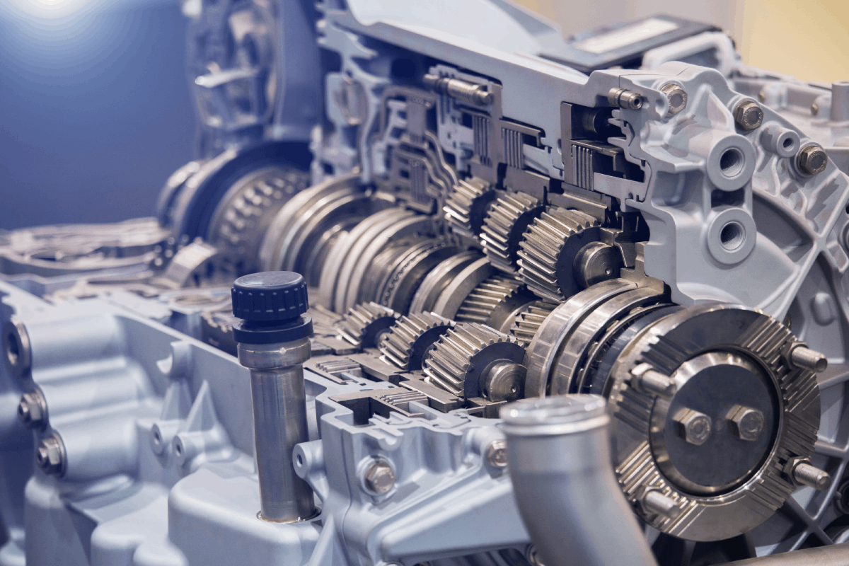Cutaway view of an automotive transmission system showcasing gears and components, relevant to vehicle transmission maintenance tips.